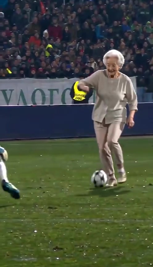An older woman recreating the Ozil goal